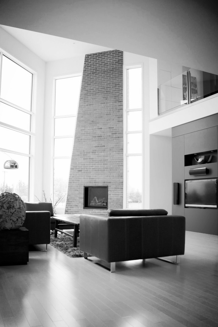 Two-storey living room with full-height brick fireplace — W Design Group project