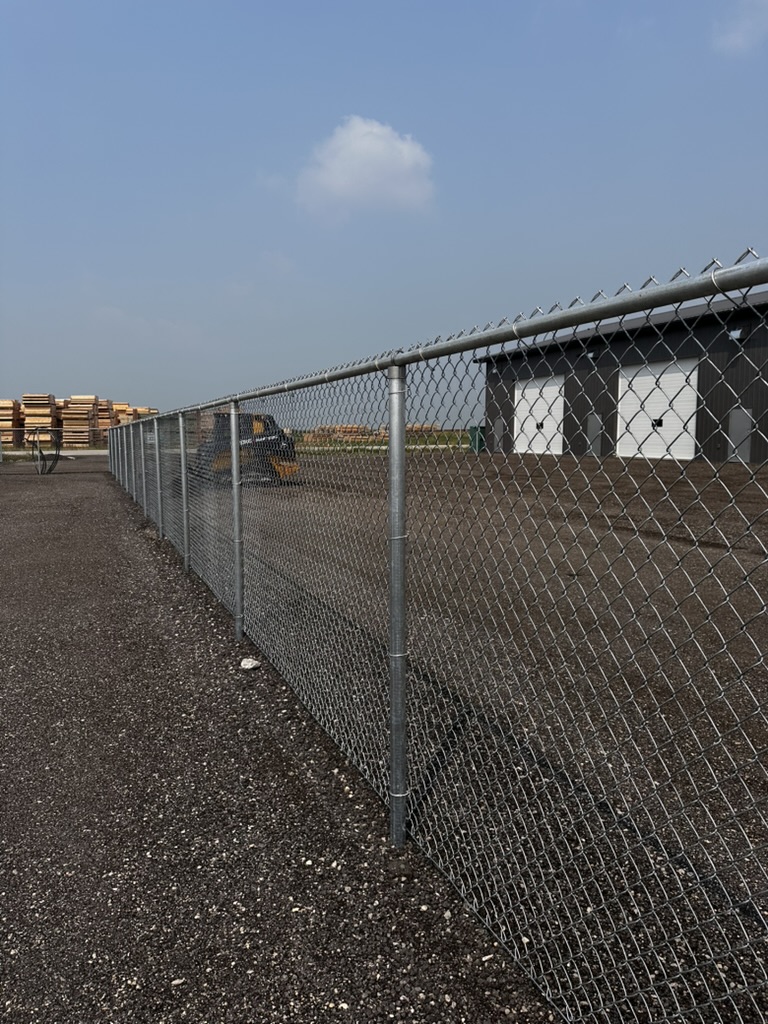 Galvanized 6 ft commercial chain link fence at an industrial lumber yard