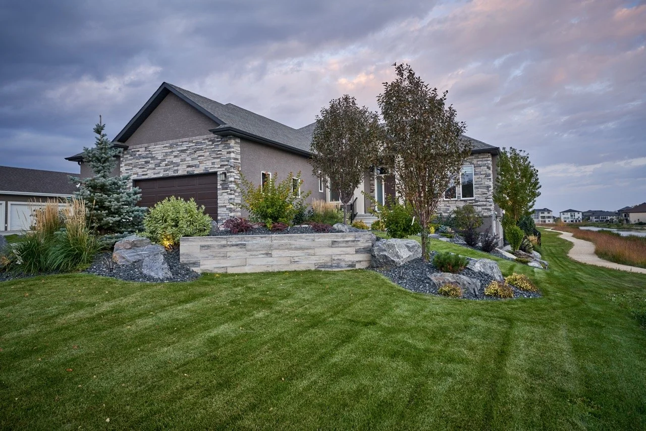 Completed landscape project by Silverstone Landscaping, showcasing a pristine front yard with lush greenery and a functi